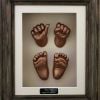 30- bronze hands & feet, dark oak frame with cream backing